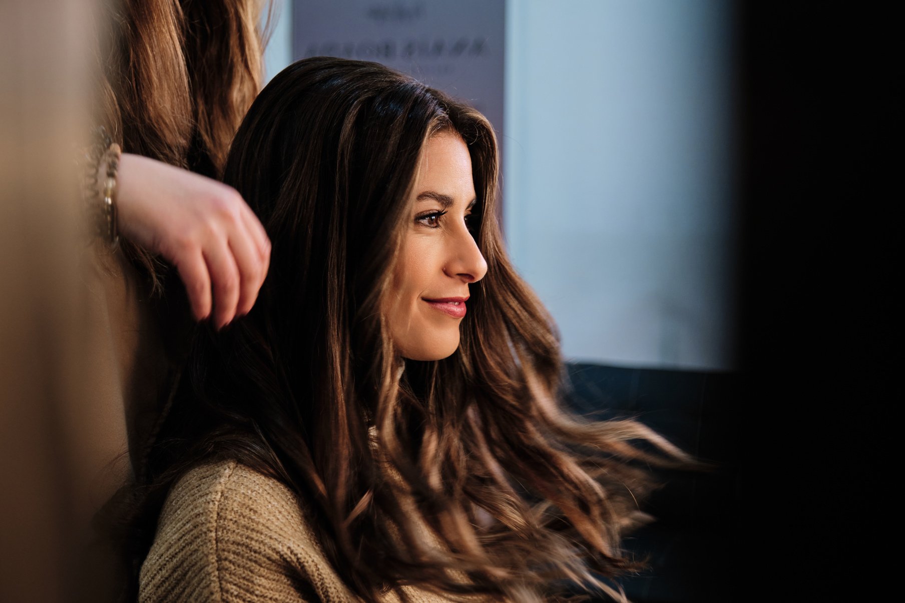 Smiling Woman Getting Her Hair Done at the Hair Salon.