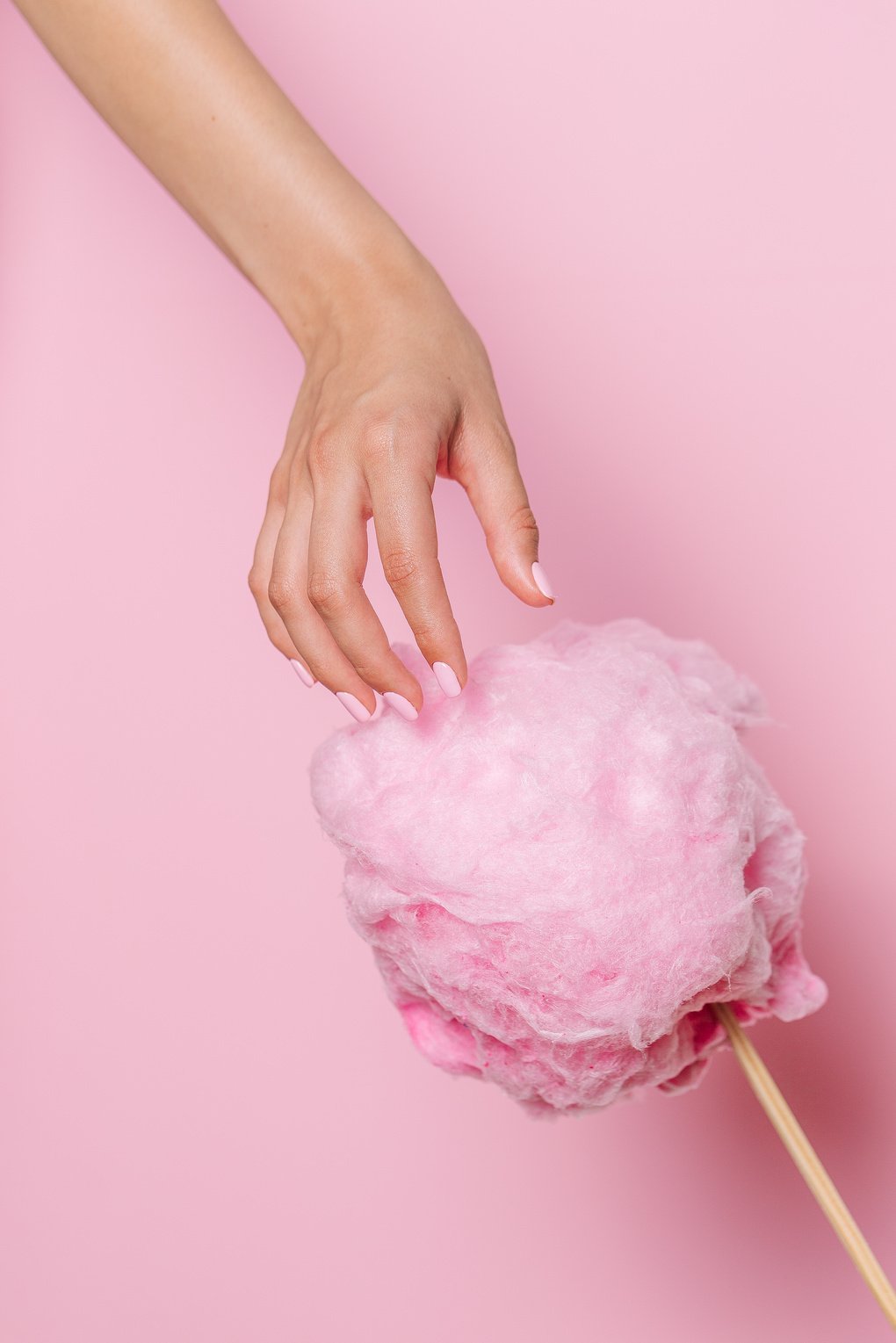 Hand Taking a Piece of Cotton Candy 